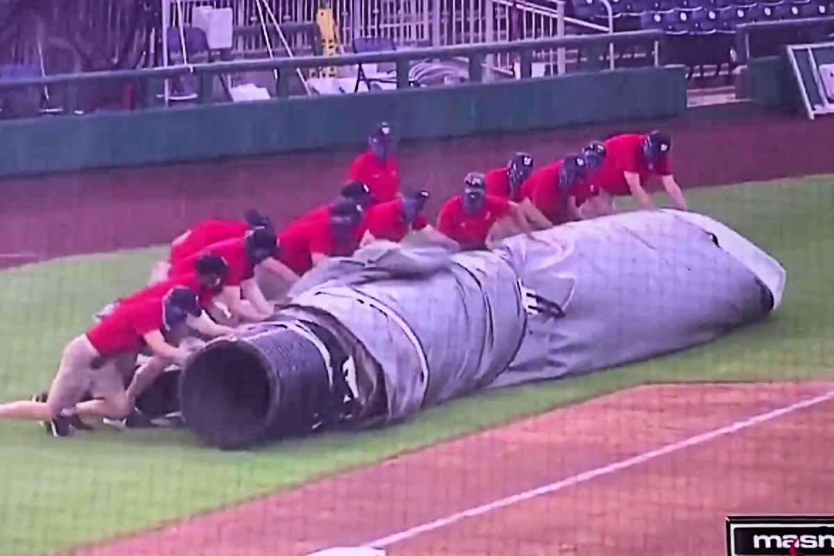 Nationals grounds crew struggles with rain tarp leads to suspension of